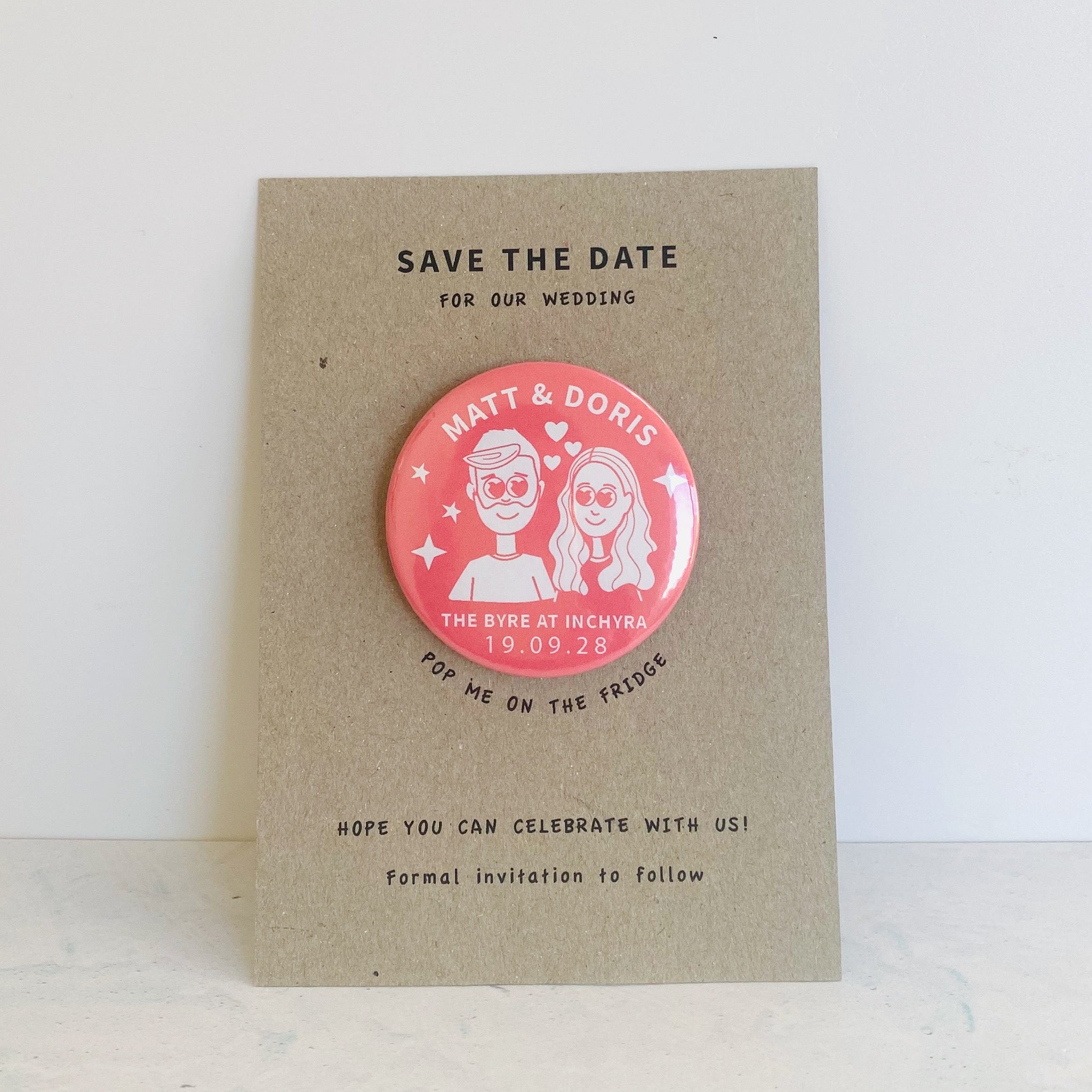 Save the date card with a pink magnet featuring a couple's illustration on a recycled card background.